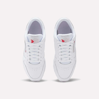 A top view of Reebok Classic Leather Shoes shows a leather upper with laces, perforated toes, and red Reebok logos on the tongues, offering a timeless retro style.