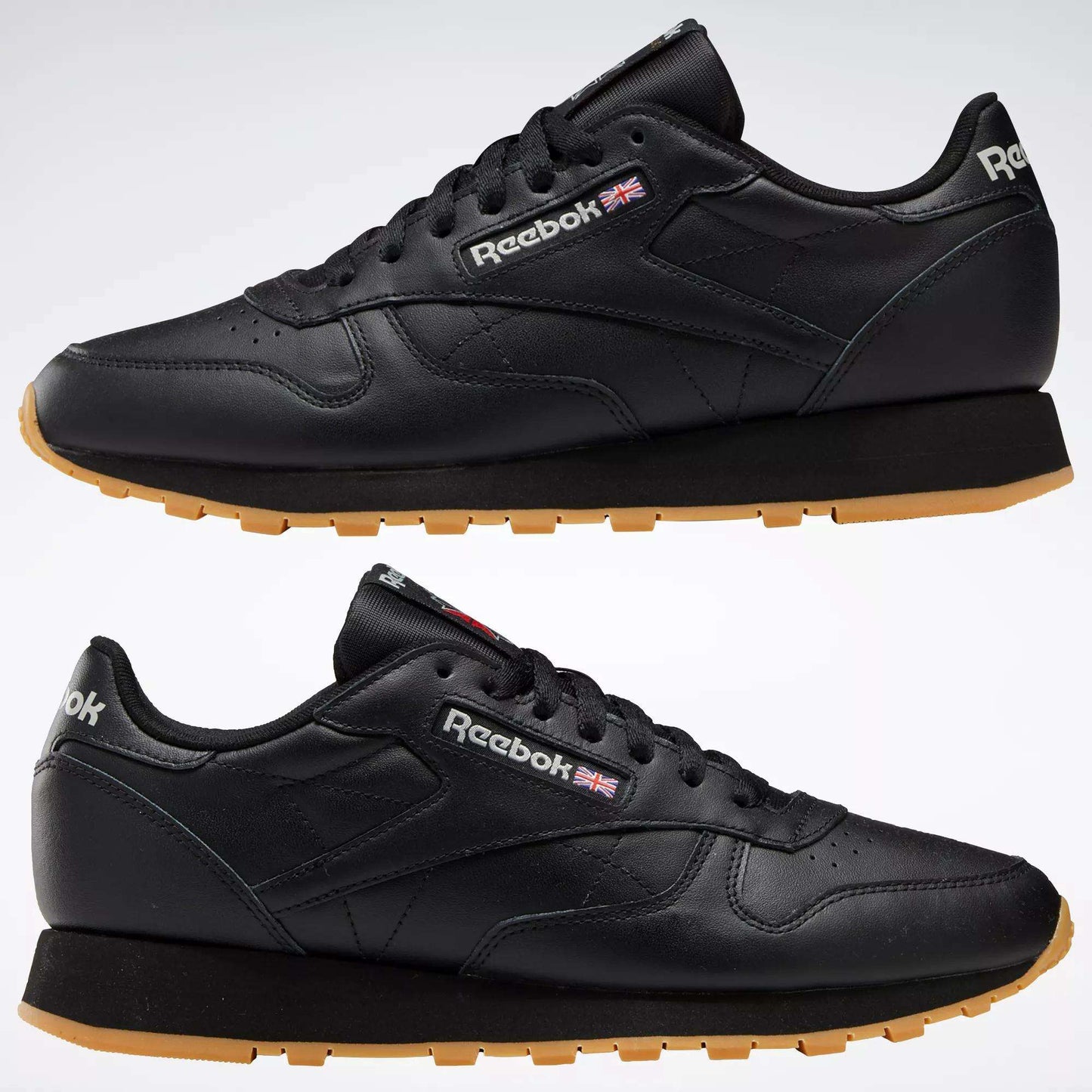Two black Reebok Classic Leather Shoes with durable leather uppers and tan rubber soles, shown from the side. The Reebok logo and Union Jack are displayed near the laces.
