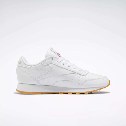 The Reebok Women's Classic Leather Shoes feature a cushioned midsole, gum sole, and subtle branding, shown in a left-side profile against a plain light background.
