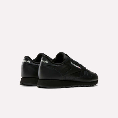 A pair of Reebok Women's Classic Leather Shoes is shown on a light background from back and side views, featuring the cushioned midsole and Reebok logo on both the heel and side.