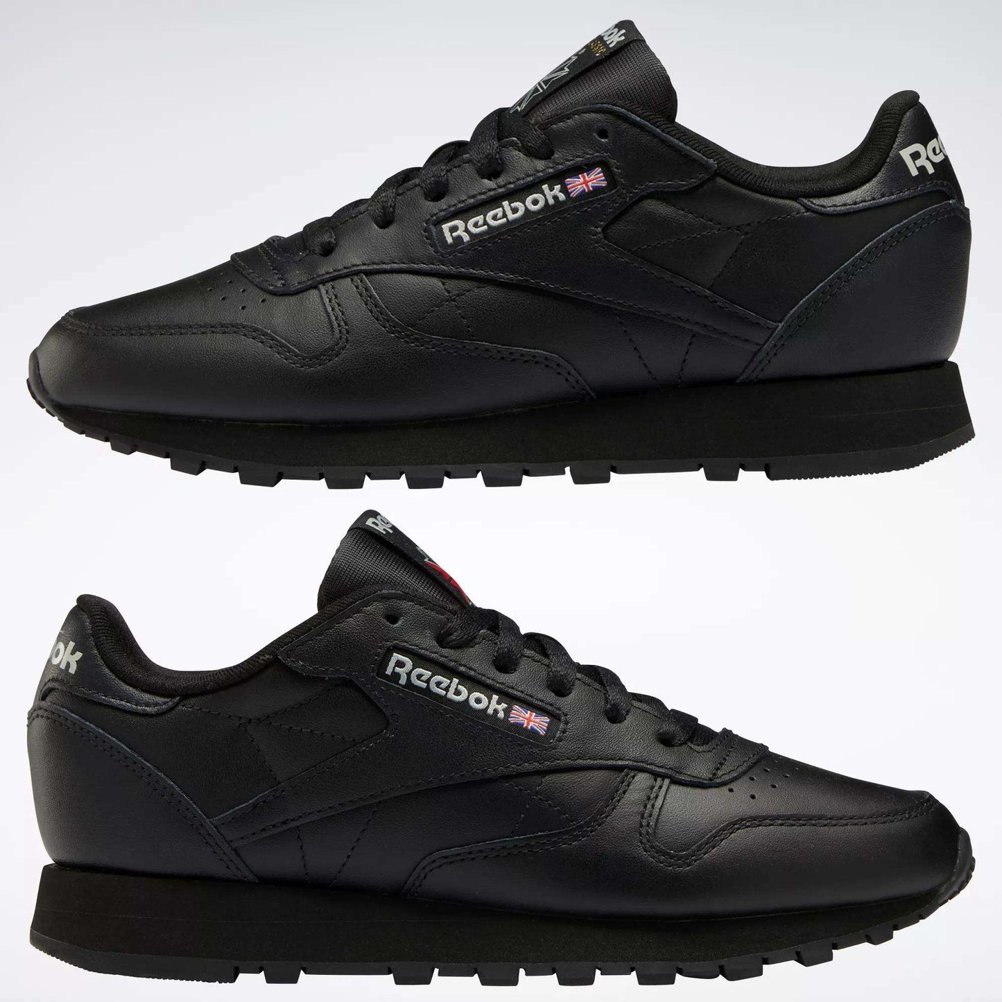Two black Reebok Women's Classic Leather Shoes are shown in side view, one above the other, on a white background. The cushioned midsole, Reebok logo, and Union Jack flag appear on the sides and heel.