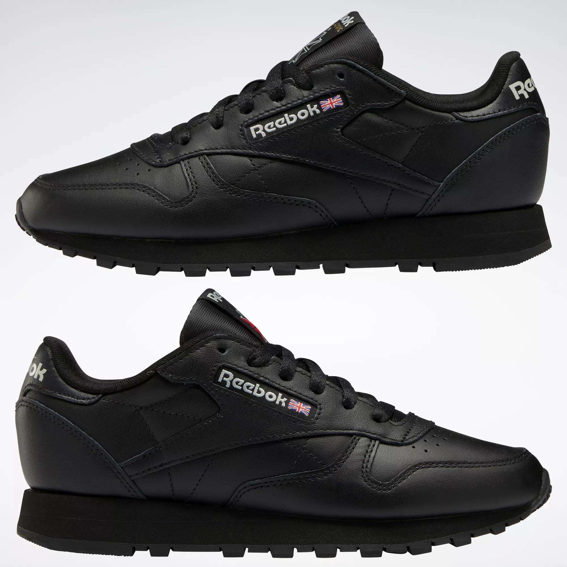 Two black Reebok Women's Classic Leather Shoes are shown in side view, one above the other, on a white background. The cushioned midsole, Reebok logo, and Union Jack flag appear on the sides and heel.