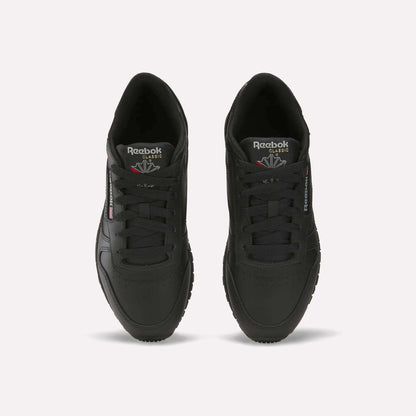A pair of Reebok Women's Classic Leather Shoes in black, seen from above with visible laces, the Reebok logo on the tongue, side branding, and a cushioned midsole, all displayed on a plain white background.