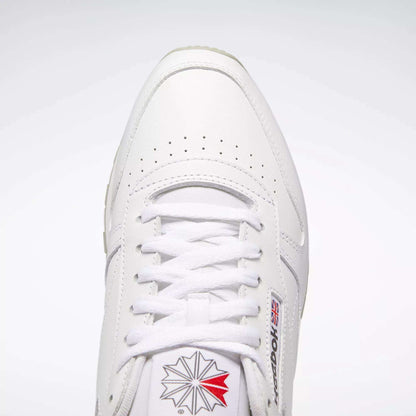 Top view of Reebok Classic Leather Shoes in white, retro style with durable leather, white laces, toe perforations, and the Reebok logo with British flag on the side and tongue against a light background.