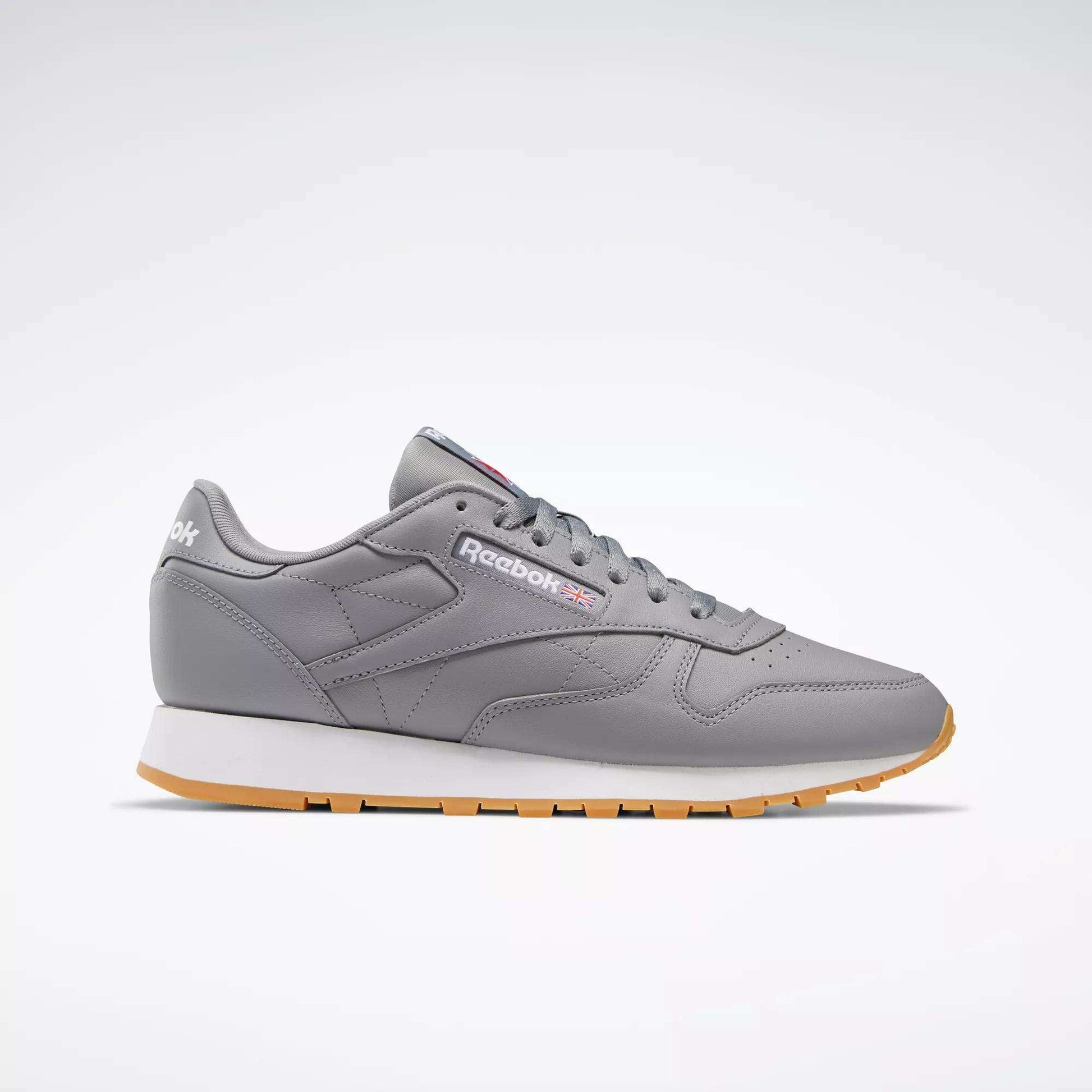 A pair of Reebok Classic Leather Shoes featuring a gray leather upper, white and gum sole, gray laces, and the Reebok logo on the side, shown on a plain white background.