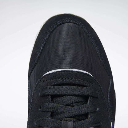 Close-up top view of the front of a black Reebok Women's Classic Nylon Shoe with black laces and a textured, rounded toe cap, shown against a plain white background.