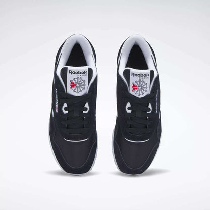 A pair of Women's Classic Nylon Shoes by Reebok in black, viewed from above. They feature white midsoles, classic Reebok branding, and a red and gray star logo on the tongues, displayed on a plain white background.