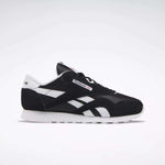 Side view of Reebok Women's Classic Nylon Shoes in black and white, featuring a white sole, black upper, and white details. These iconic sneakers are a versatile everyday choice for women, set against a simple light background.