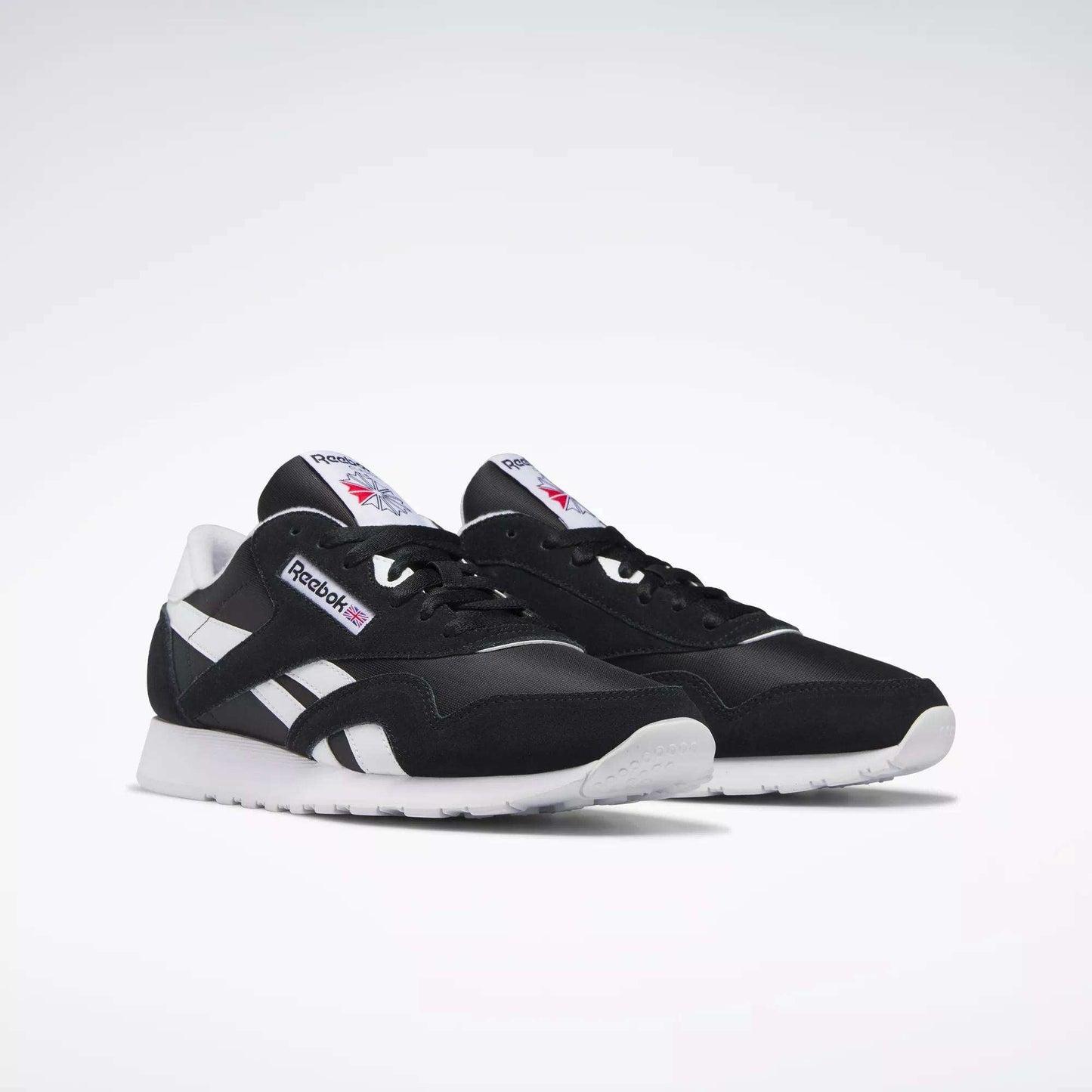 Men's Classic Nylon Shoes by Reebok in black and white, featuring the iconic logo on the side and tongue plus white soles, shown on a plain white background—perfect everyday sneakers for effortless style.