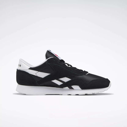 The Reebok Men's Classic Nylon Shoes feature a black and white design with a white sole, side detailing, and heel tab, showcased on a plain light background.