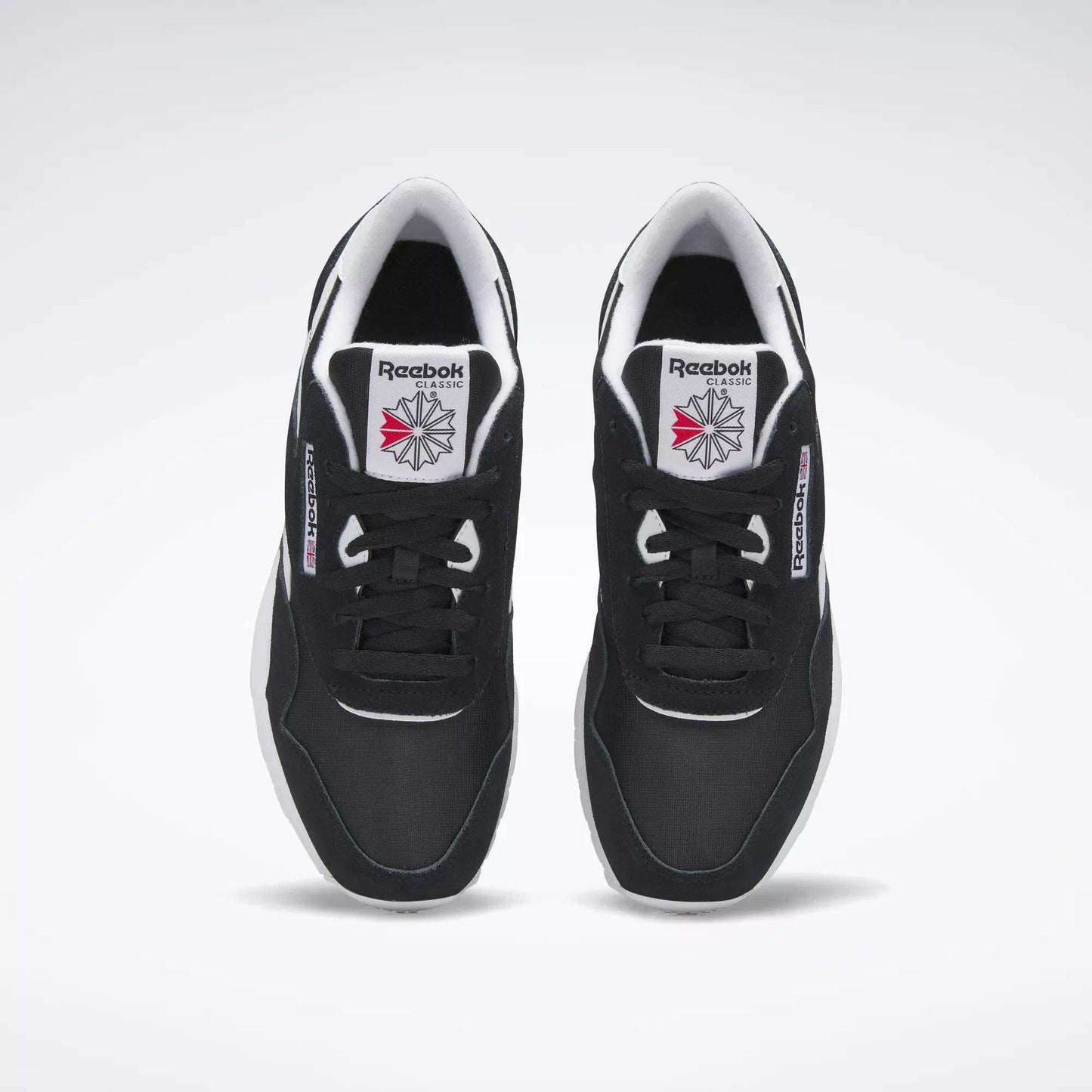 A pair of Men's Classic Nylon Shoes by Reebok in black with white soles and the Reebok logo on the tongue, viewed from above on a plain white background—perfect classic sneakers for everyday wear.