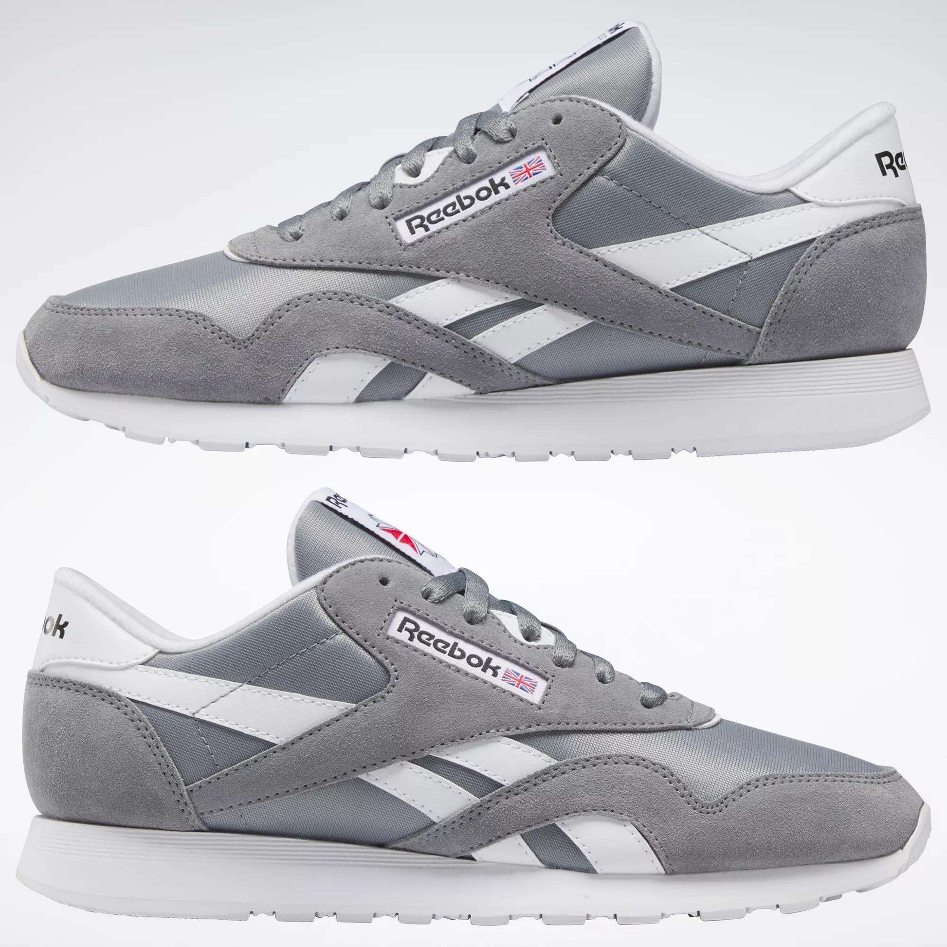 The Reebok Men's Classic Nylon Shoes are shown in gray and white from both sides on a plain white background, featuring a durable nylon upper, white laces, a white sole, and the iconic Reebok logo with a small British flag.