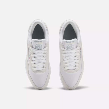 A pair of Men's Classic Nylon Shoes by Reebok in white, seen from above with white laces, light gray accents, and the Reebok logo on the tongue and side—timeless sneakers set side by side on a plain white background.