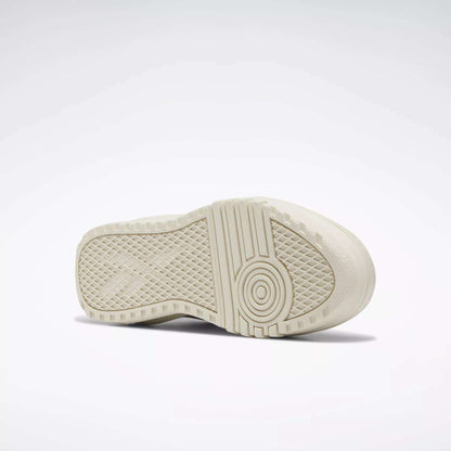 A close-up of the off-white rubber sole on Reebok Women's Club C Extra Shoes, showing its geometric tread pattern and platform midsole, set against a plain white background.