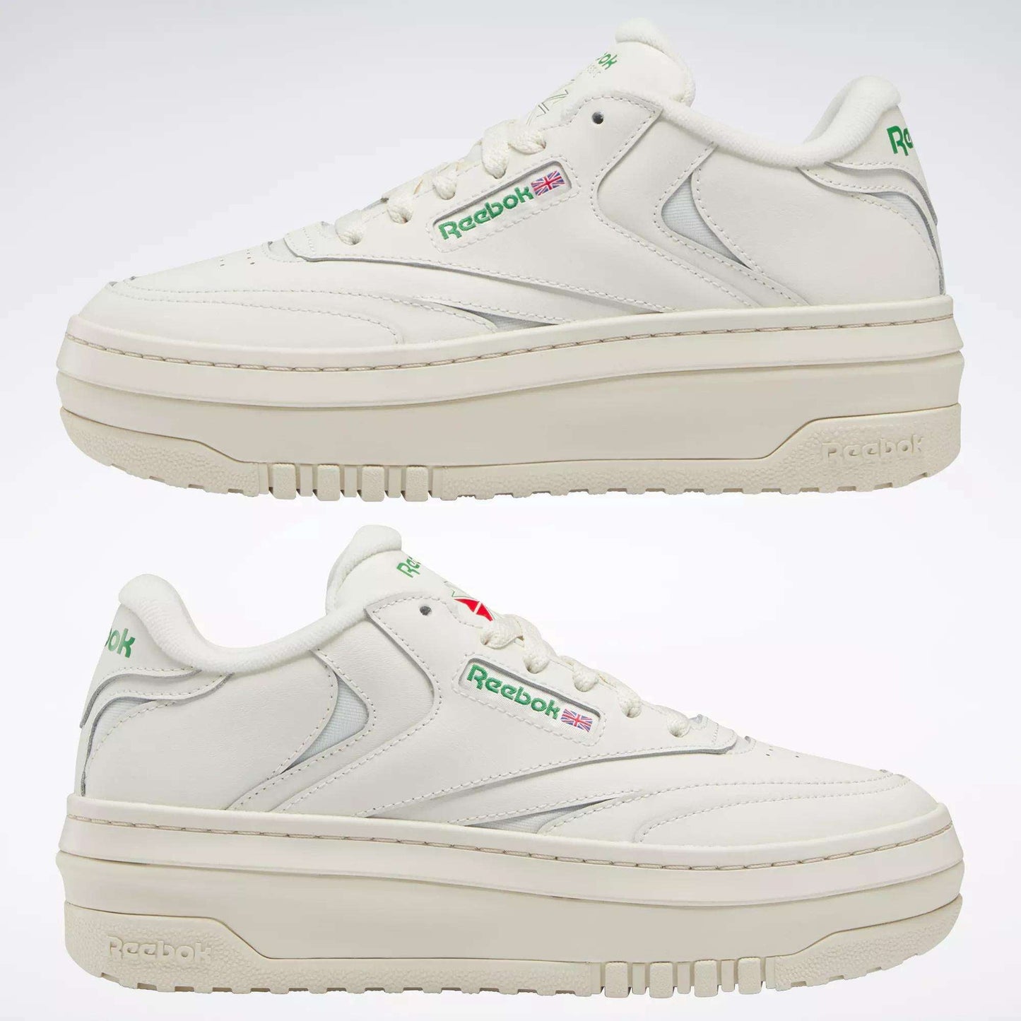 Two white Reebok Women's Club C Extra Shoes with thick platform midsoles, green and red logos, and grey accents are shown side by side against a plain light background.