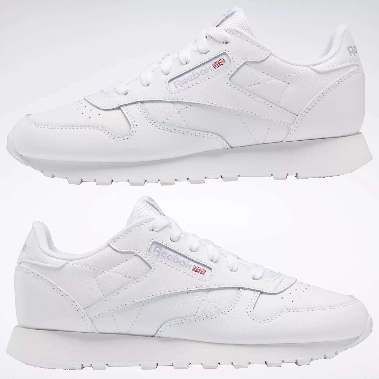 Two white Reebok Classic Leather Shoes - Big Kids are displayed side by side on a plain white background, showcasing the signature design and Reebok logo—ideal as stylish footwear for junior boys.