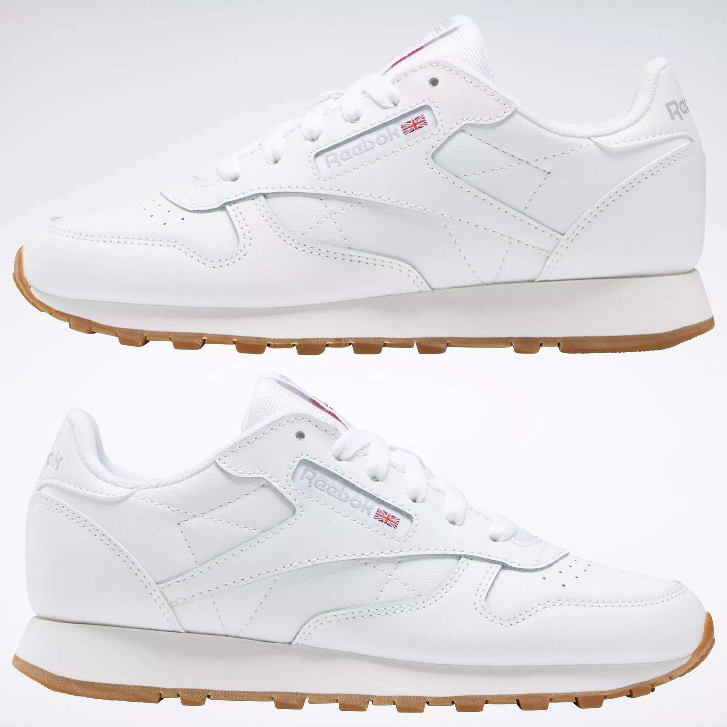 Two Reebok Classic Leather Shoes - Big Kids with gum soles and stitched side-stripes are shown side by side on a plain background, displaying both outer and inner views. The Reebok logo and Union Jack appear on the sides.