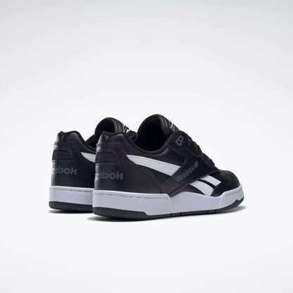 A pair of Reebok BB 4000 II Shoes in black leather with white soles and side stripes are shown on a plain white background, angled to display the back and side views.