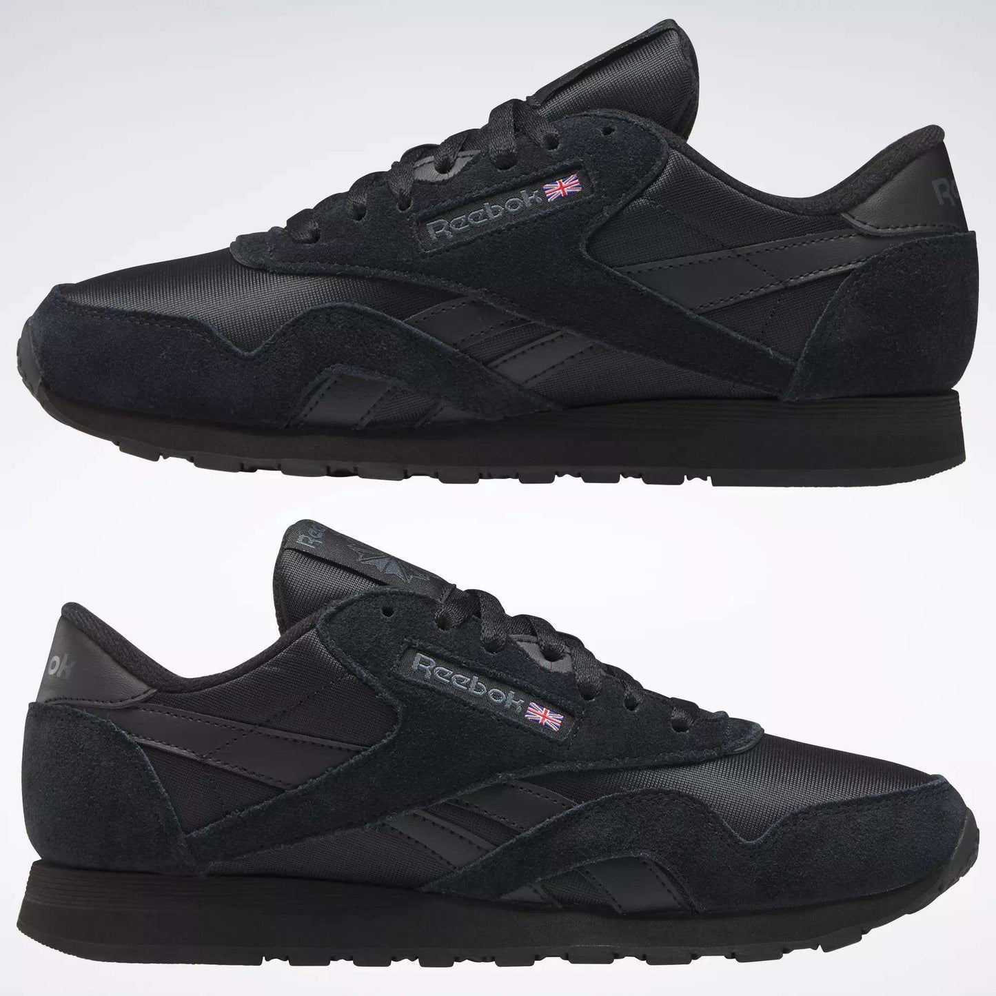 A pair of black Reebok Men's Classic Nylon Shoes with suede, mesh, and nylon upper details, classic branding, and a Union Jack flag on the side—shown in left view on a plain background. Perfect for everyday wear.