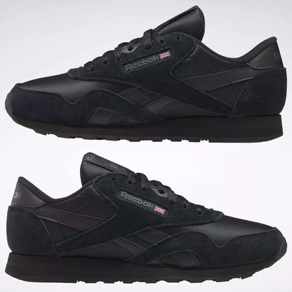 A pair of black Reebok Men's Classic Nylon Shoes with suede, mesh, and nylon upper details, classic branding, and a Union Jack flag on the side—shown in left view on a plain background. Perfect for everyday wear.