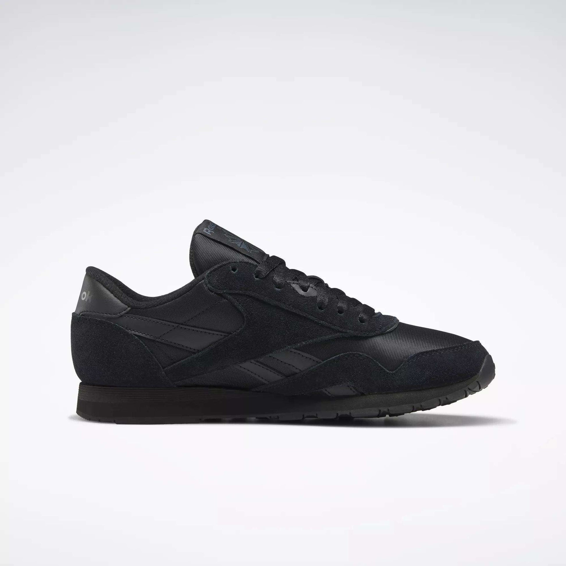A men's Reebok Classic Nylon shoe in black is displayed in a side profile on a plain white background, highlighting its versatility for everyday wear.