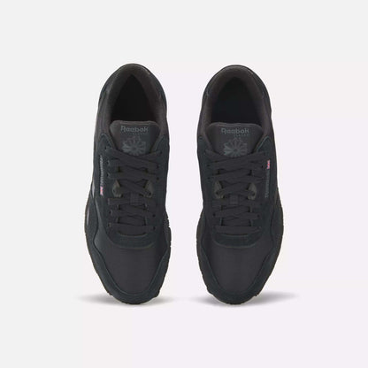 A pair of Men's Classic Nylon Shoes by Reebok, shown from above on a white background, features a black nylon upper, laces, tongue logo, and subtle side branding.