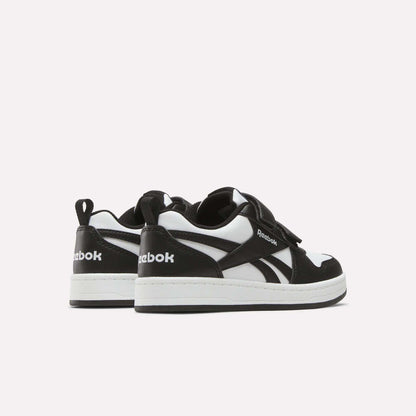 Kids' Reebok Royal Prime 2 Shoes by Reebok in black and white, featuring white soles, hook-and-loop straps, and the Reebok logo on the side and heel, shown against a plain light background.