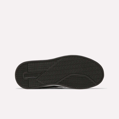 The image shows the sole of a black Kids' Reebok Royal Prime 2 Shoe featuring textured grip patterns and the Reebok logo on the left side, set against a plain white background.