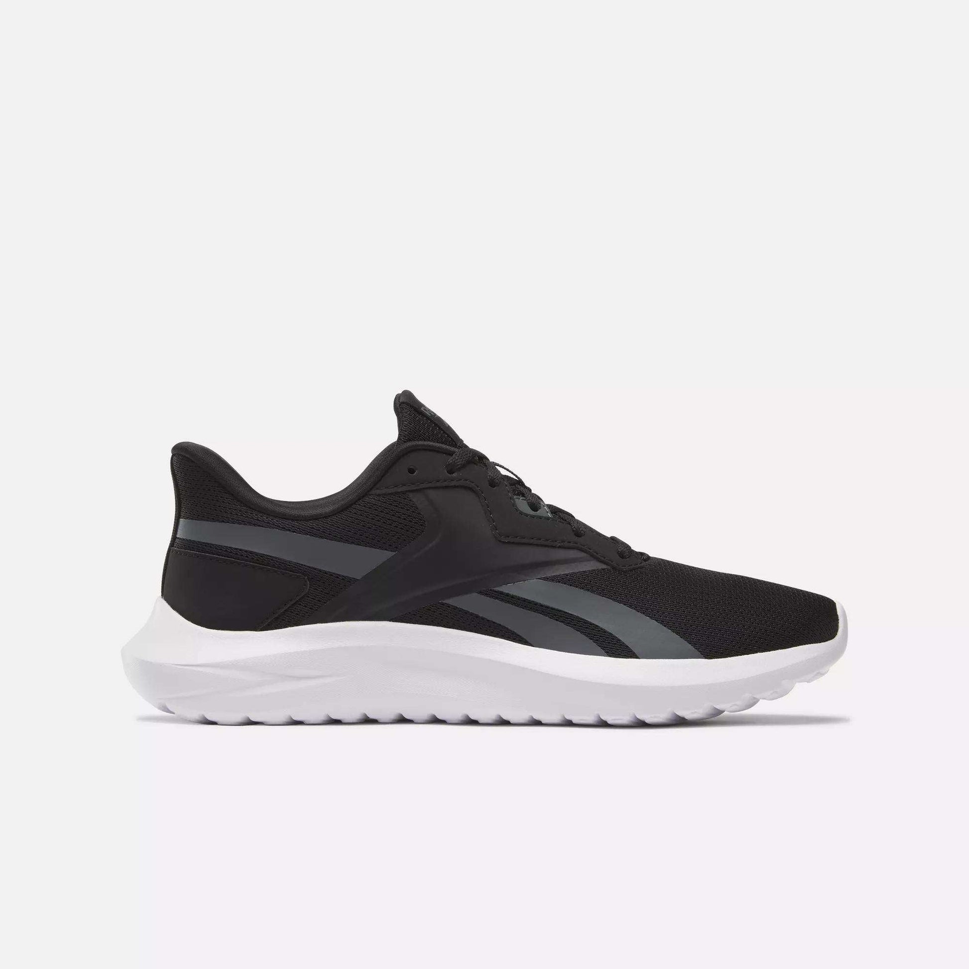 The Men's Energen Lux Running Shoes by Reebok feature a black mesh upper, white sole, and dark gray accents—versatile athletic sneakers ideal for running or everyday wear, shown from the side on a light background.