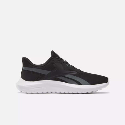 The Men's Energen Lux Running Shoes by Reebok feature a black mesh upper, white sole, and dark gray accents—versatile athletic sneakers ideal for running or everyday wear, shown from the side on a light background.