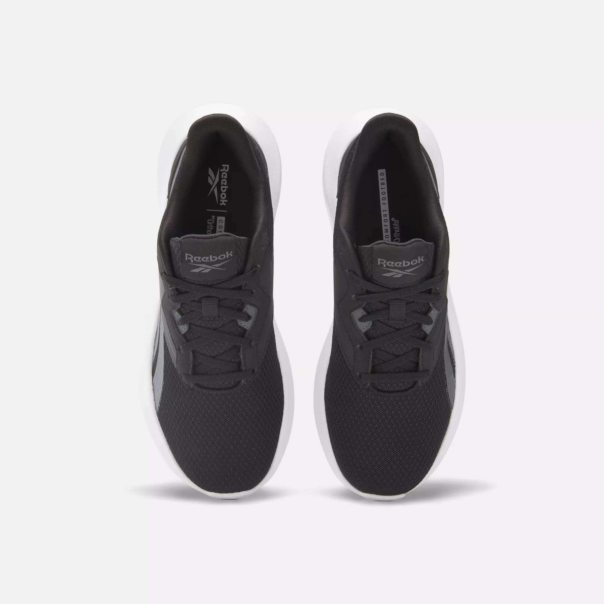 Top view of Women's Energen Lux Running Shoes by Reebok, featuring mesh uppers, laces, and white soles for breathability and comfort, displayed side by side on a light gray background.