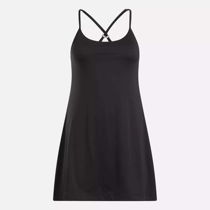 The Reebok Women's Lux Strappy Dress, in black stretch knit, features thin crisscross back straps and is shown against a plain light background.