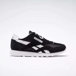 The Reebok Classic Nylon Shoes - Big Kids are displayed in black and white from a side angle on a white background, showcasing the iconic Reebok logo, white stripes, and sole—ideal for those who love minimalist style.