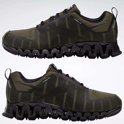 Reebok Men's ZigWild Trail 6 Shoes in olive green and black, featuring zigzag-patterned soles, mesh uppers, and enhanced cushioning, are displayed side by side on a plain white background.