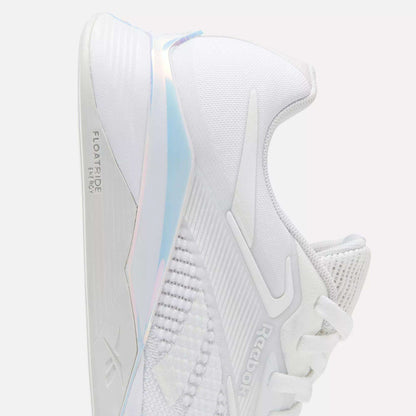 The image shows a Reebok Nano X4 Women's Training Shoe in white, viewed from the side. It features a breathable mesh upper, Reebok branding, and "FLOATRIDE ENERGY" text on the thick sole.