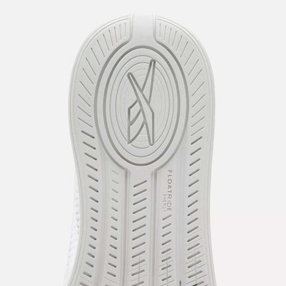 Close-up of the white sole on Reebok Nano X4 Women's Training Shoes featuring an oval pattern, stylized X logo at the center, and FLOATRIDE ENERGY text engraved beside textured grip lines.