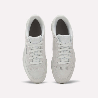 A top-down view of Reebok Club C 85 Shoes in white, showcasing clean laces, a suede upper, toe perforations, and light gray soles on a plain white background.