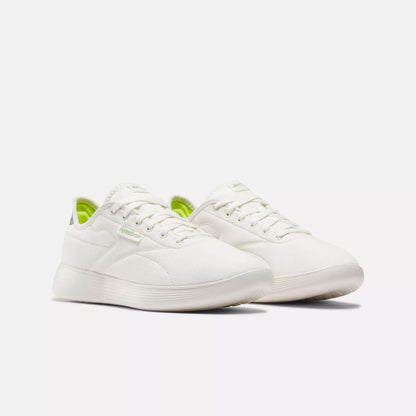 The Reebok Active Lite Shoes feature a minimalist white design with subtle side branding, a hint of lime green on the inner lining, and a 3-D Foam midsole for comfort, shown against a plain white background.