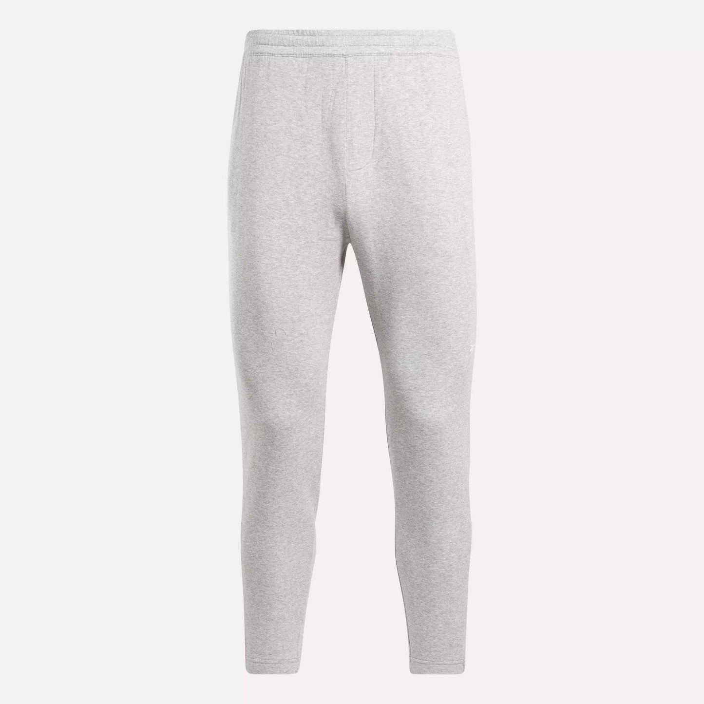 The Reebok Men's Active Collective DreamBlend Pants in light gray feature a slim, tapered leg, soft DreamBlend fabric, and an elastic waistband, shown here on a plain white background.