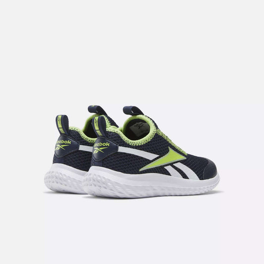 A pair of Reebok Rush Runner Slip-On Shoes for little kids in navy blue with white soles, neon green and white accents, lightweight cushioning, and heel pull tabs, shown on a light gray background.