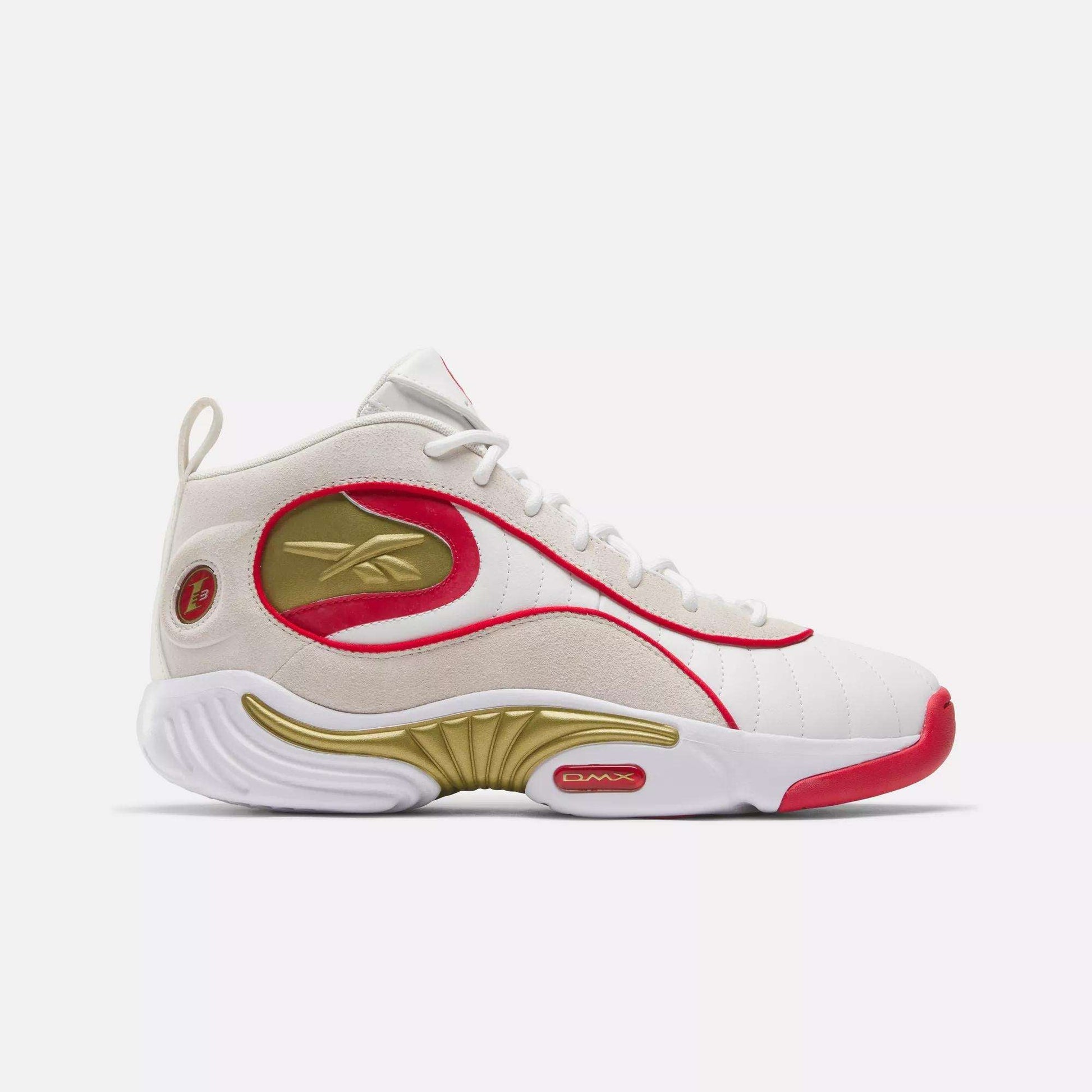 The Reebok Answer III Basketball Shoes are white high-tops with red and gold accents, a gold logo, red trim, and white laces. The outsole features curved gold and red designs, inspired by classic Allen Iverson sneakers.