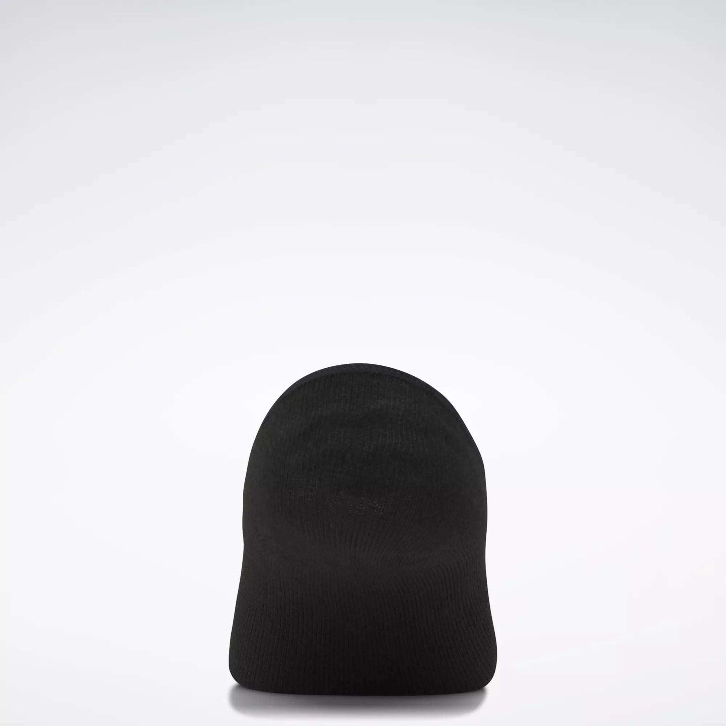 A plain black beanie hat is displayed upright against a simple light gray background, echoing the minimalist style of Women's Reebok Sport Liner Socks 6 Pairs by Reebok.