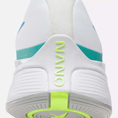Close-up of the heel of the Reebok Nano X4 Training Shoes, a lightweight white trainer with "NANO" in neon yellow-green on the back, turquoise and blue accents, and a textured white sole featuring a neon green section.