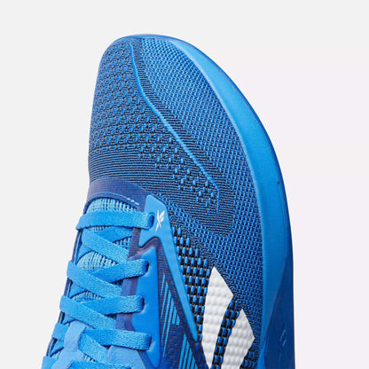 Close-up of the toe and side of the Reebok Nano X4 Training Shoes, featuring blue breathable mesh fabric, blue laces, and white accent stripes.
