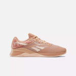 A single Women's Nano X4 Training Shoe by Reebok in peach with white accents and a patterned heel is shown in side profile on a plain white background—this lightweight, breathable design suits active lifestyles.