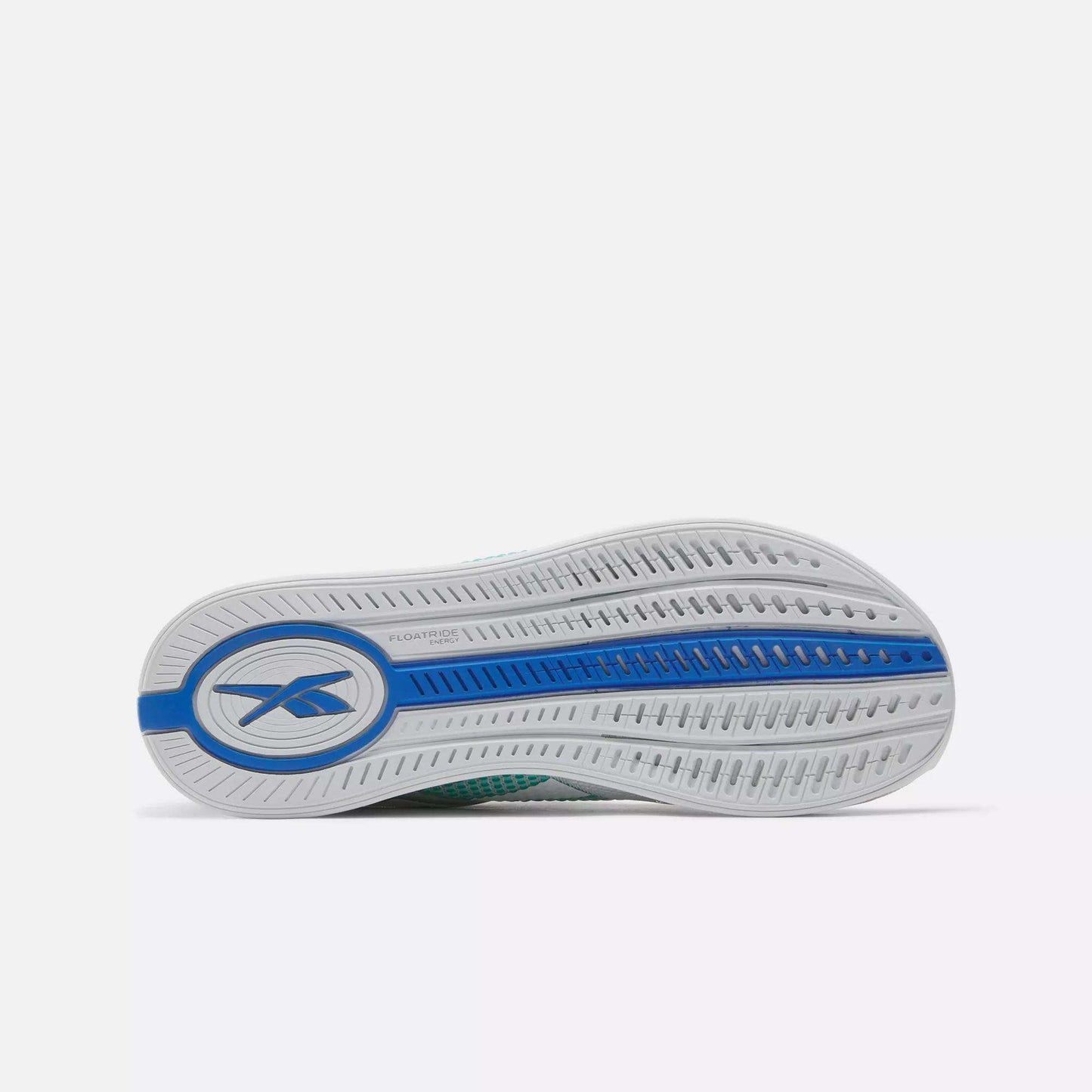 The image displays the sole of Reebok Women's Nano X4 Training Shoes, featuring a mostly white base with blue accents and the Reebok logo by the heel. The lightweight sole has textured grooves for traction and a curved design.