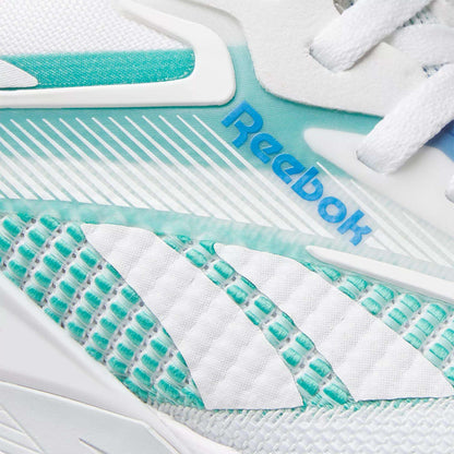 Close-up of Reebok Women's Nano X4 Training Shoes with the blue logo, white laces, and a textured design in white and teal with geometric patterns—lightweight and perfect for your workouts.