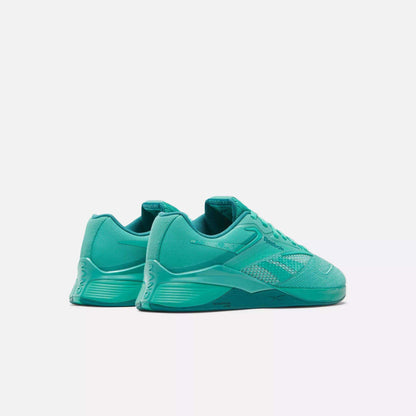 The Reebok Women's Nano X4 Training Shoes in teal are shown angled to display the side and back, featuring mesh and synthetic details, lace-up closure, and a textured sole—lightweight trainers on a plain white background.
