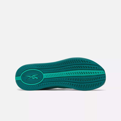 The image displays the green sole of Reebok Women's Nano X4 Training Shoes, featuring a lightweight design, textured tread pattern, and Reebok logo near the heel, set against a plain light background.