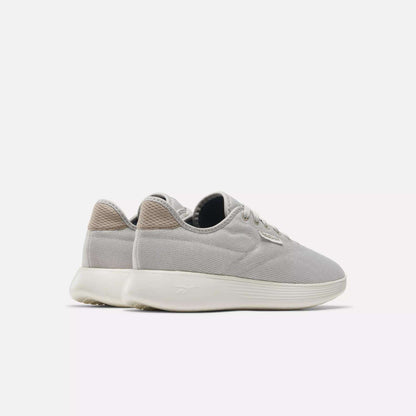 The Reebok Active Lite Shoes are minimalist sneakers in light gray with white soles and beige heel accents, shown side by side on a plain white background.